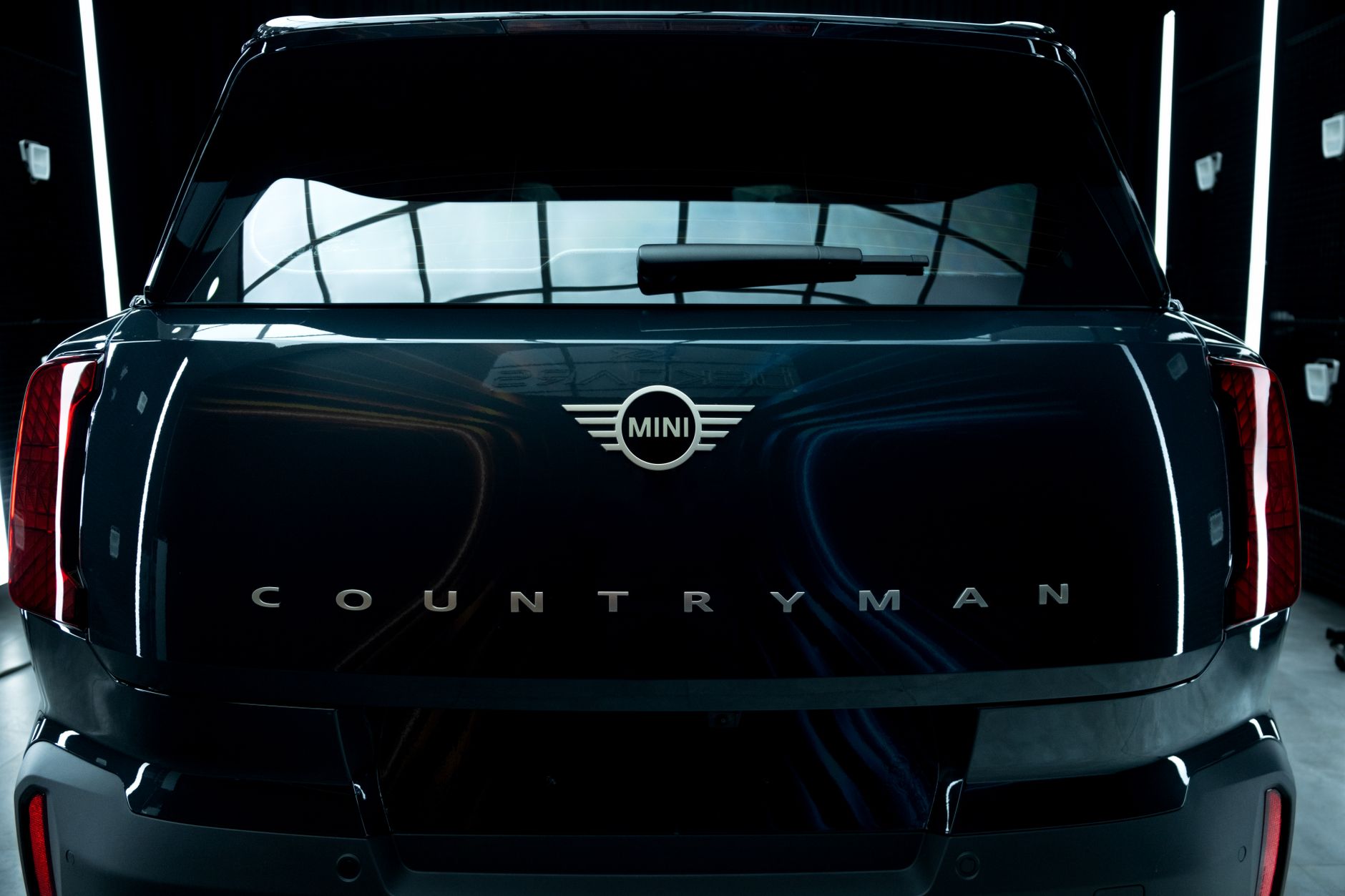 Rear view of the Mini Countryman highlighting its elegant design in a modern showroom.