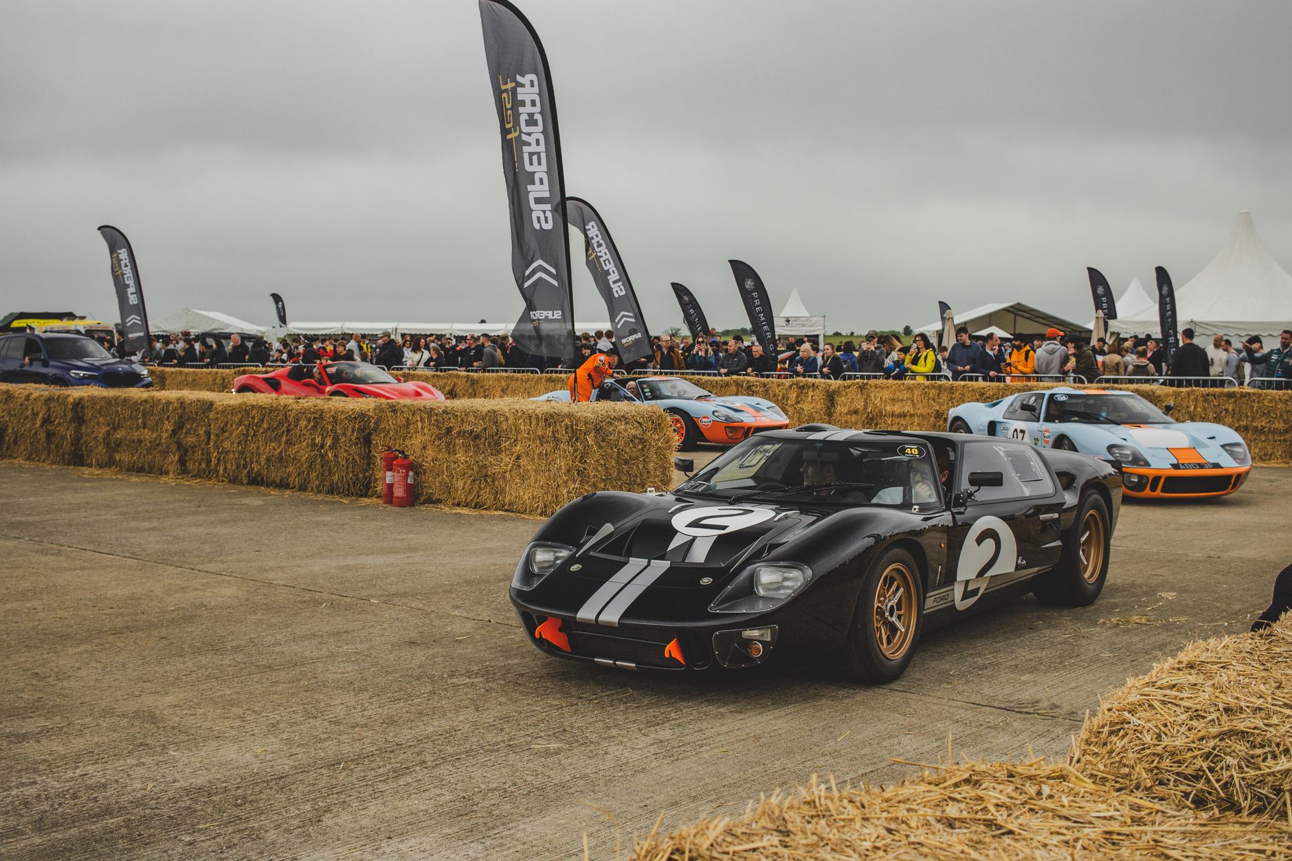 Vintage Ford GT40 sports cars captured at an exciting motorsport event.