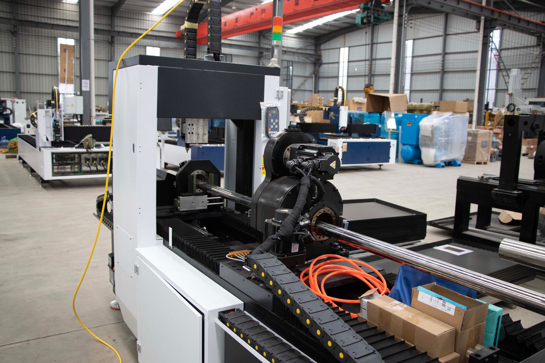 Advanced CNC machine and equipment in a spacious factory environment, showcasing industrial manufacturing.