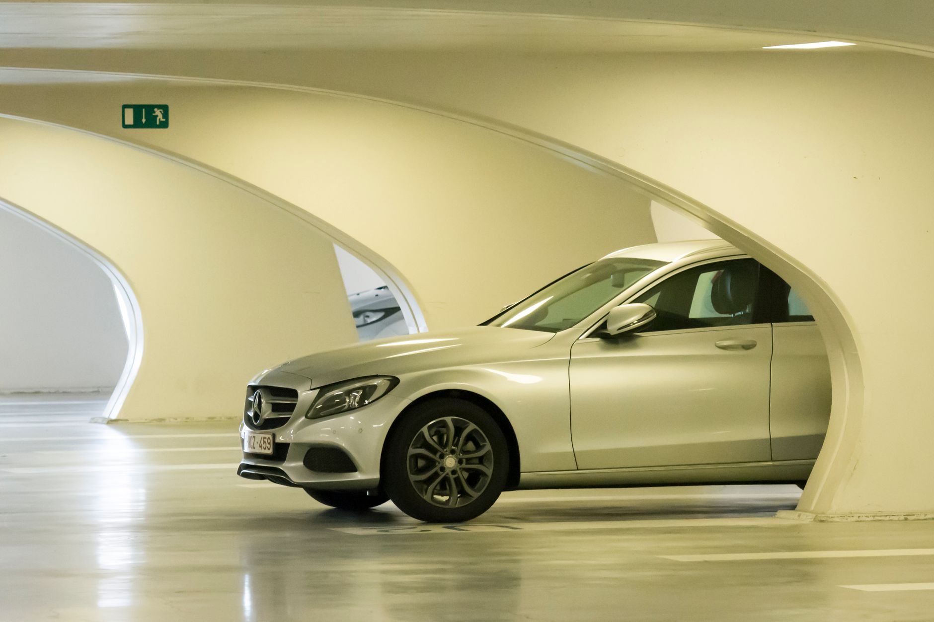 Stylish Mercedes-Benz C Class car parked in a contemporary garage with unique architecture.