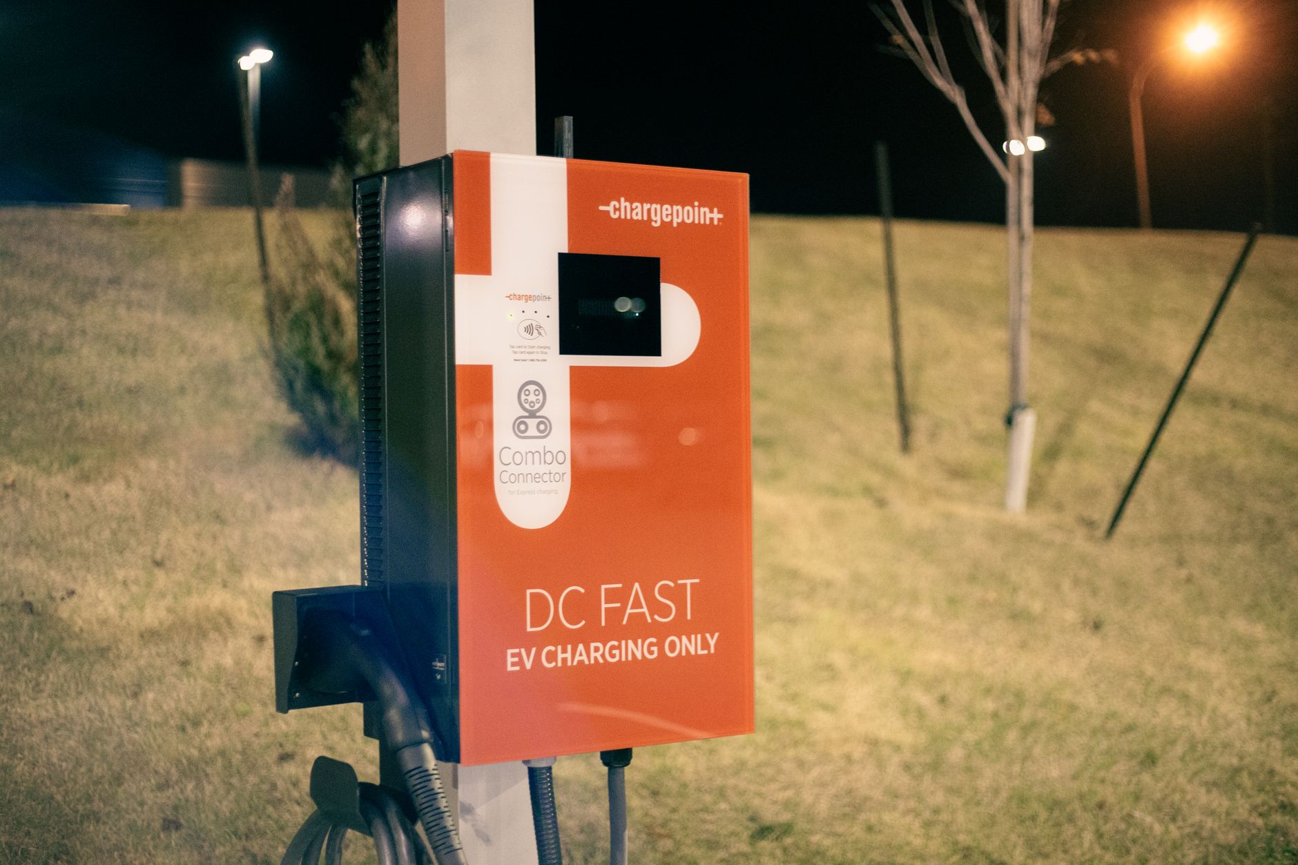 Electric recharging point for vehicles working on eco friendly energy source against hill on roadside at night