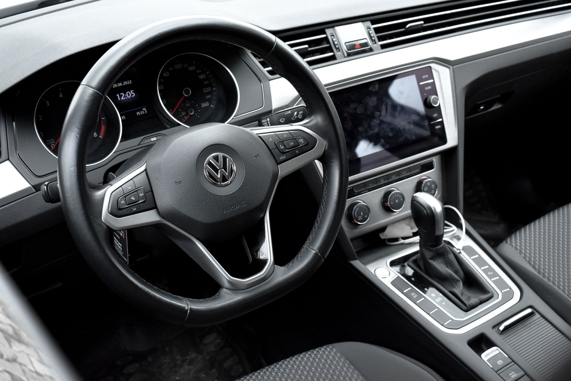 Detailed view of a Volkswagen car interior showcasing the steering wheel, dashboard, and gear shift.