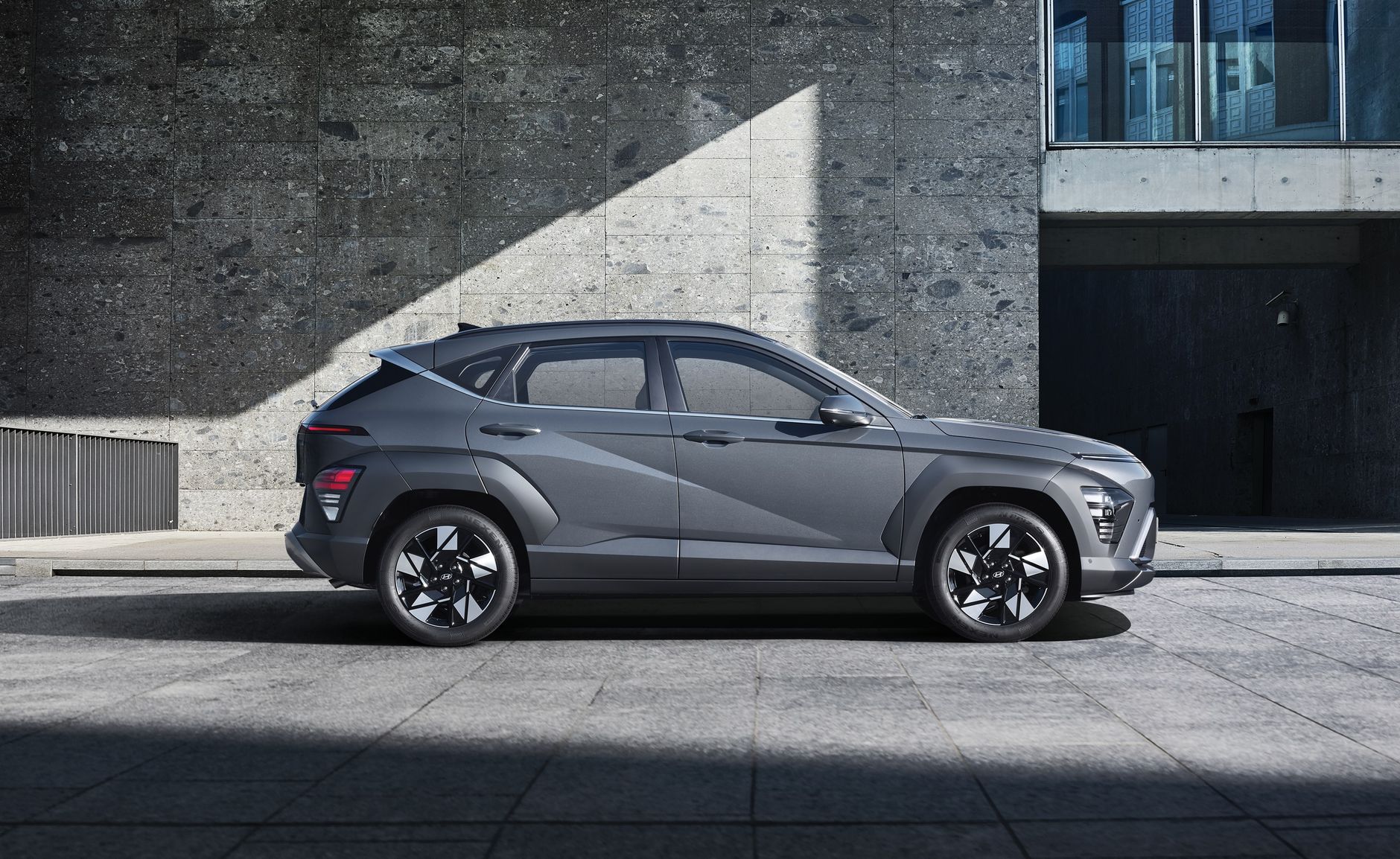 A sleek gray SUV parked in an urban environment, showcasing modern design.