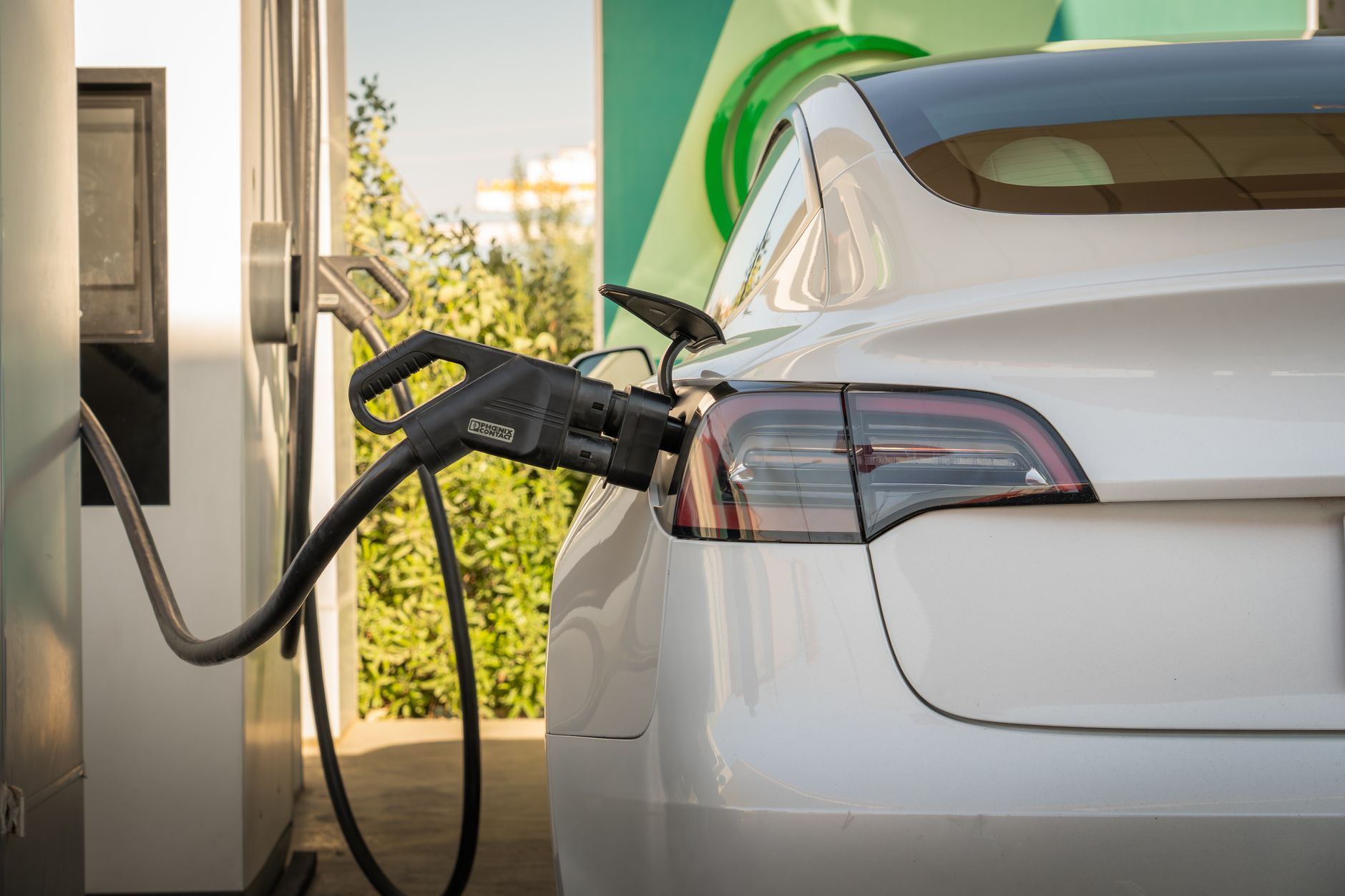 Electric Tesla car charging at a station in Erbil, Iraq. Eco-friendly transportation.