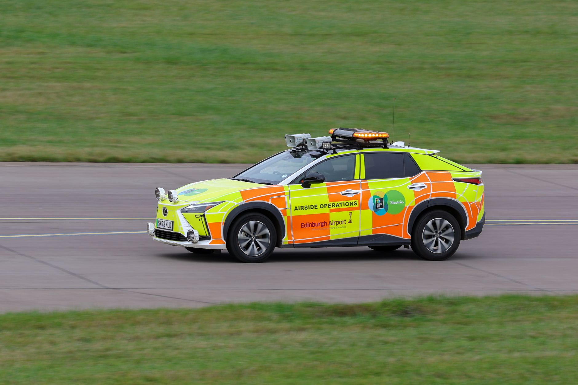 Electric airside operations vehicle at Edinburgh Airport, Scotland, for runway safety.